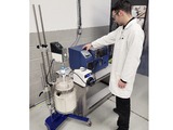 AMT clean room operation using a Coflore® flow reactor fed by an efficiently stirred vessel in a ReactoMate ATOM stand.